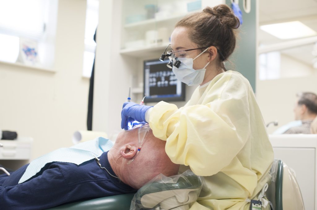 Dental Hygiene student is working with patient at Manor College dental hygenist school 