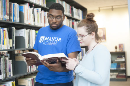 students read book in Manor College library