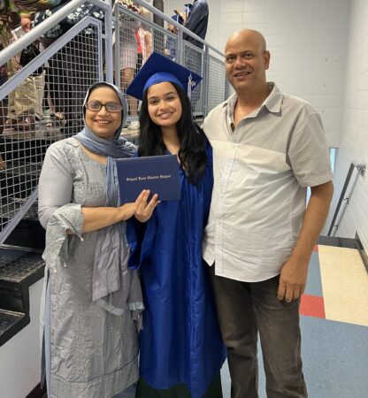 A family poses together after a high school graduation. 