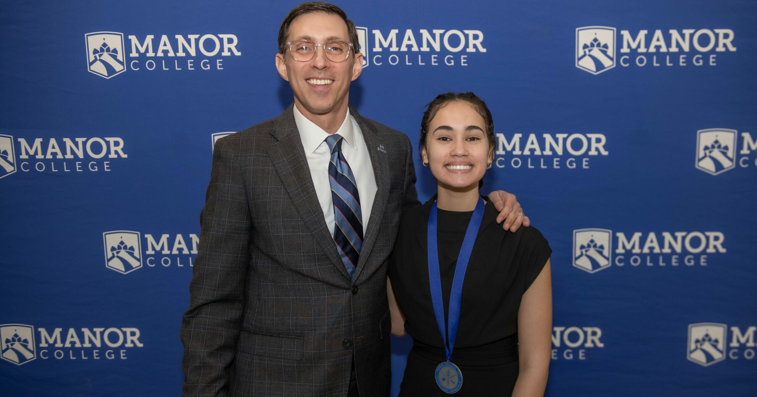 Dr. Jonathan Peri poses with Mother Josaphat Medal Winner Neysha Medina