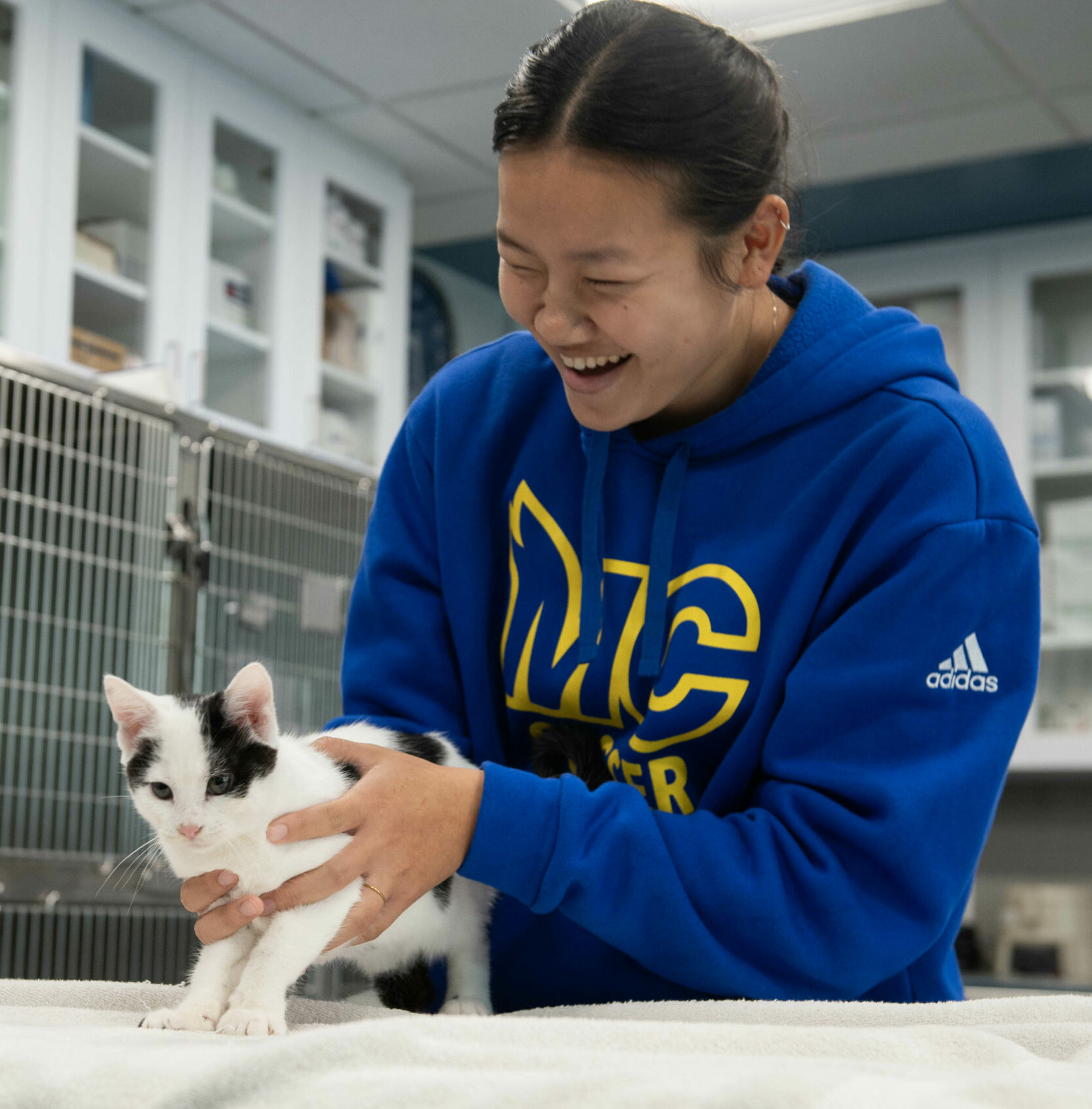 female student examining a kitten