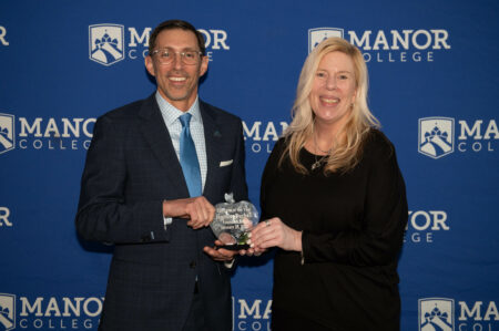Professor Jennifer Buechel (right) receives the Educator of the Year award from Manor College President Dr. Jonathan Peri. 