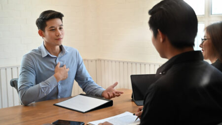 Young man talking with interview job in modern office.