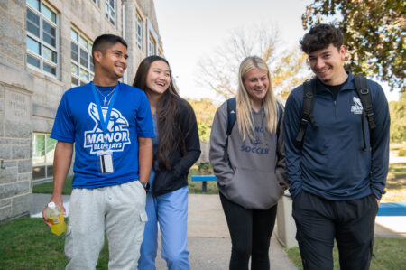 smiling Manor students walking around campus